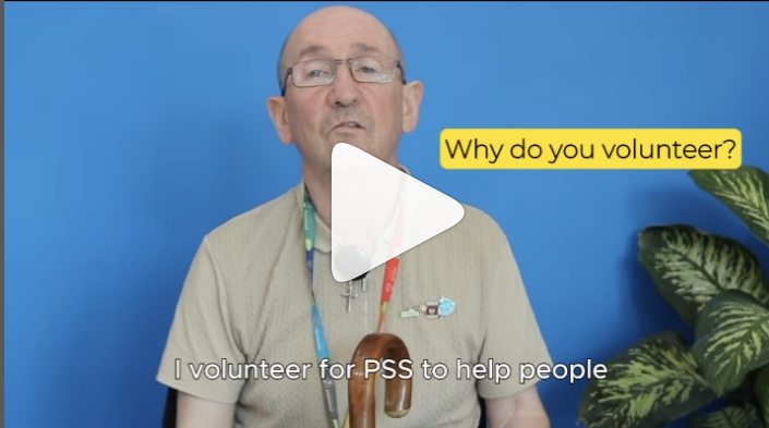 A screenshot of a video made with one of the people PSS supports through Shared Lives. Kevin is a white man, with glasses and a walking stick just ins hot. He is wear a beige polo neck. His closed caption says 'I volunteer for PSS to help people' and there is a header: 'Why do you volunteer?'